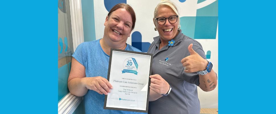 Two ladies holding award certificate